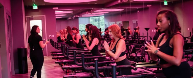 Lagree class performing Megaformer exercises with instructor in TIGHT Dallas studio