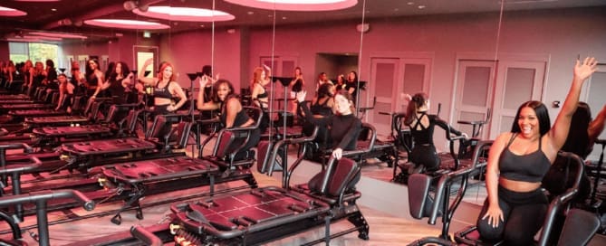 TIGHT Dallas instructors all waving and ready on the Megaformer M3X's in their Studio in Dallas, Texas ready for the holiday fitness challenge