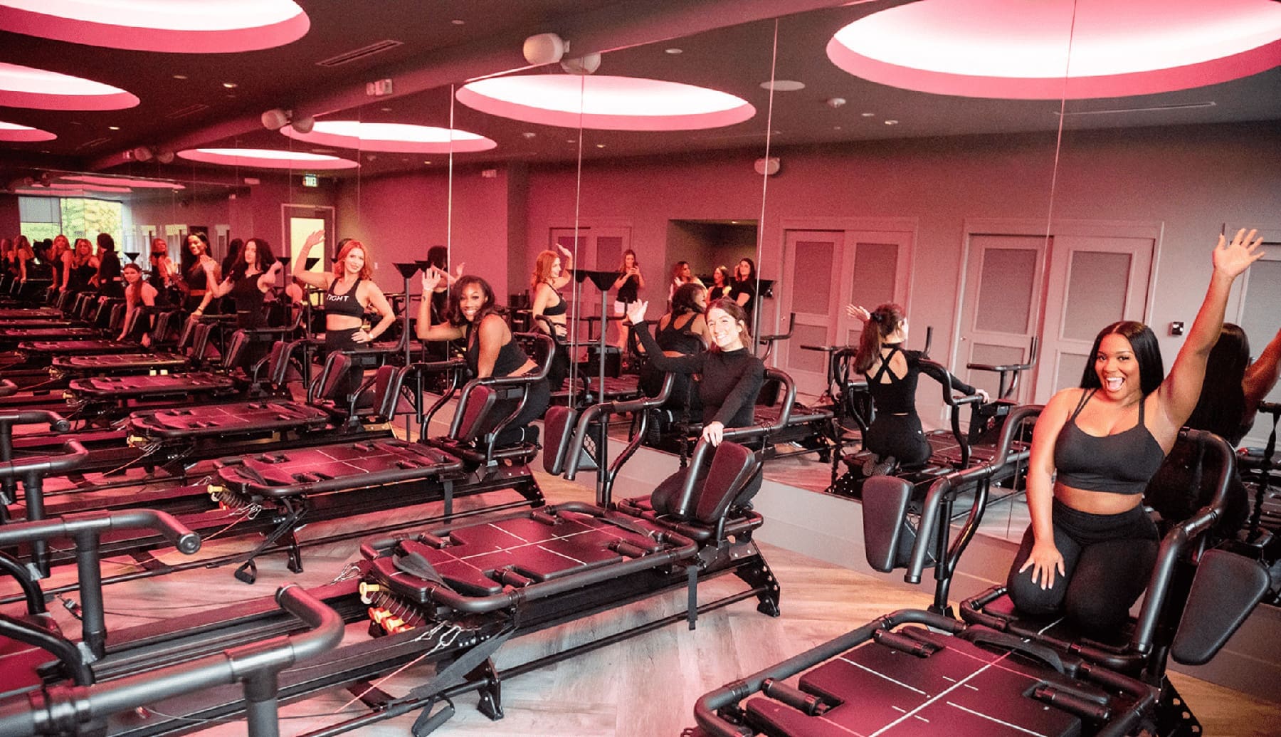 Sleigh The Season: 20 Days of Fitness with TIGHT Dallas TIGHT Dallas instructors all waving and ready on the Megaformer M3X's in their Studio in Dallas, Texas ready for the holiday fitness challenge